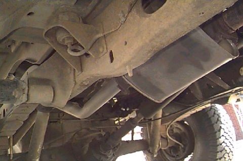 1980 Ford Bronco - Underside view of the exhaust system and suspension, showing various components and the tire tread.
