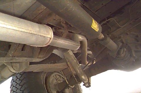1980 Ford Bronco - Vehicle exhaust system and suspension parts are visible from underneath.