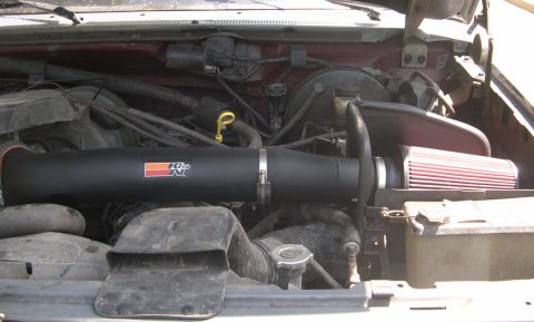 1989 Ford Bronco - Close-up of an engine bay, focusing on an aftermarket K&N air intake system.