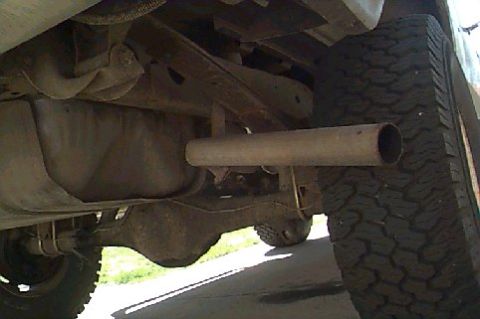 1980 Ford Bronco - Close-up view of a vehicle's undercarriage, focusing on the exhaust system and rear axle.