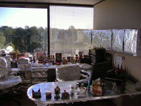 1991 Ford Bronco - An office cubicle is completely covered in aluminum foil, including the desk, chair, and walls.