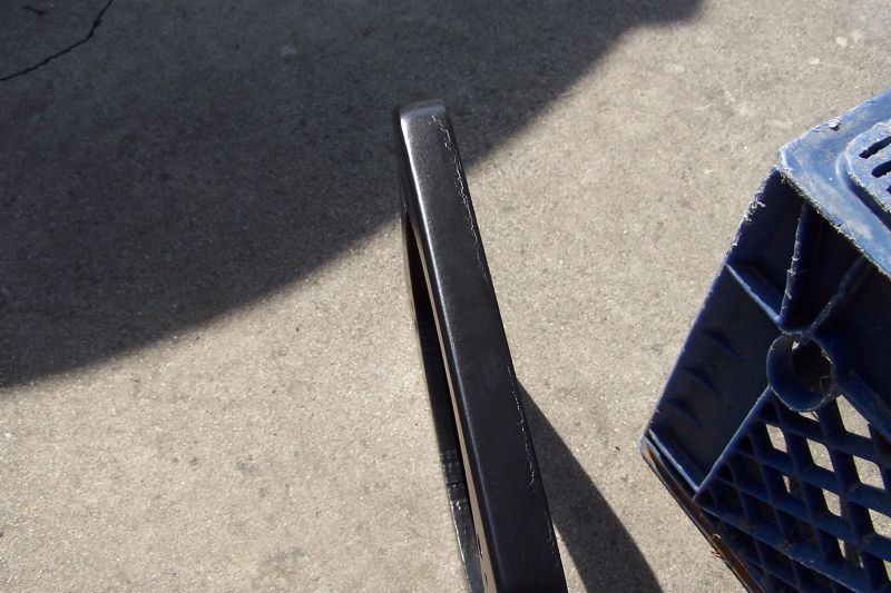 Black speaker adapter next to blue plastic crate on concrete