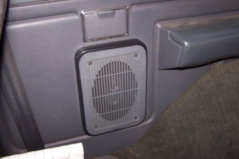 1990 Ford Bronco - Close-up of the speaker adapter integrated into the door panel of a 1990 Ford Bronco.