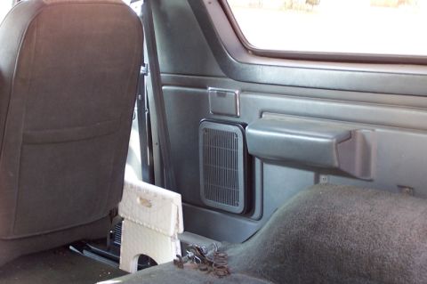 1990 Ford Bronco - The interior of a 1990 Ford Bronco shows the rear seat and a speaker grille on the side panel.
