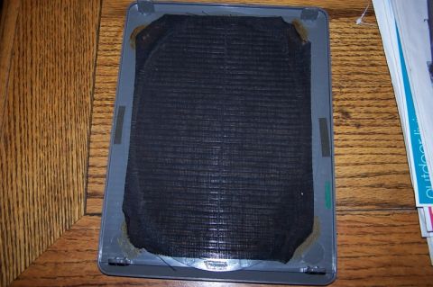 1990 Ford Bronco - Speaker grille with black mesh and gray plastic frame, likely from a car interior.