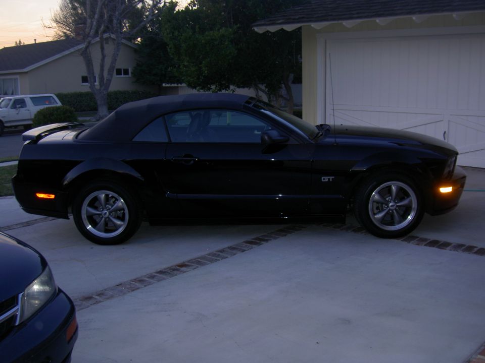 Black 2005 Ford Mustang GT convertible parked in driveway