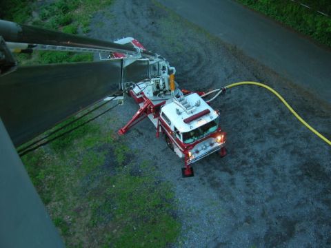 1989 Ford Bronco - A red and white fire truck is shown from an aerial perspective, connected to a yellow hose.