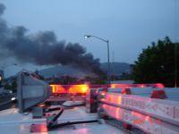 1989 Ford Bronco - Emergency lights are visible on the roof of a vehicle, with smoke rising in the distance.