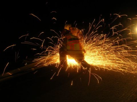 1989 Ford Bronco - A person operates an angle grinder at night, illuminating the darkness with a spectacular display of sparks.