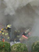 1989 Ford Bronco - Firefighters work through thick smoke at a scene.
