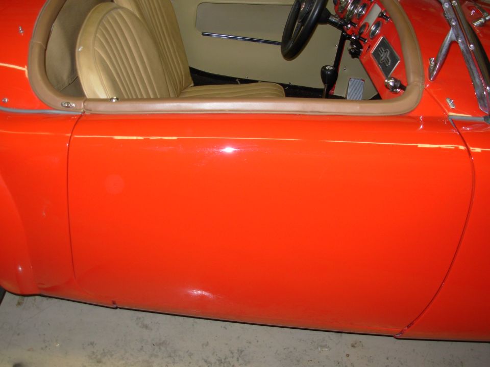The flash is washing out some of the color.  The car is actually very red.