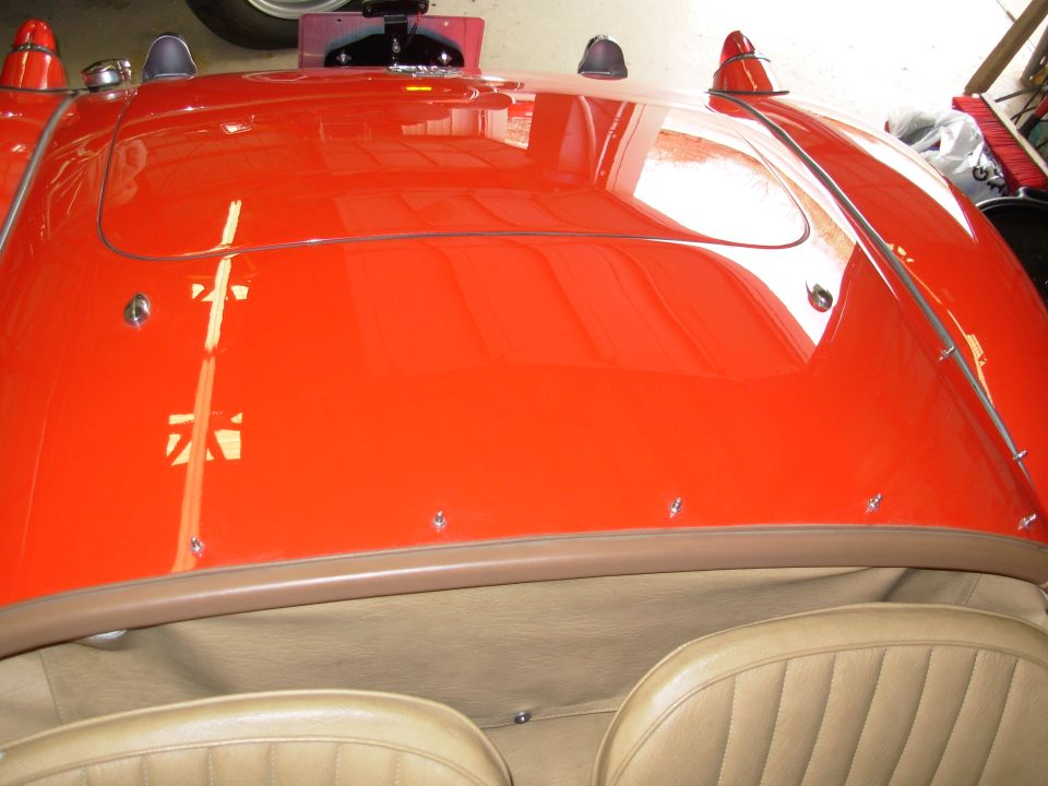 The flash is washing out some of the color. The car is actually very red.