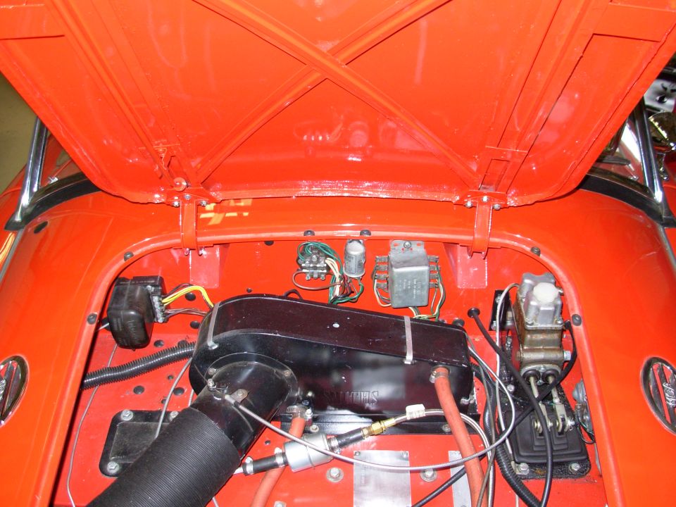 The flash is washing out some of the color. The car is actually very red.