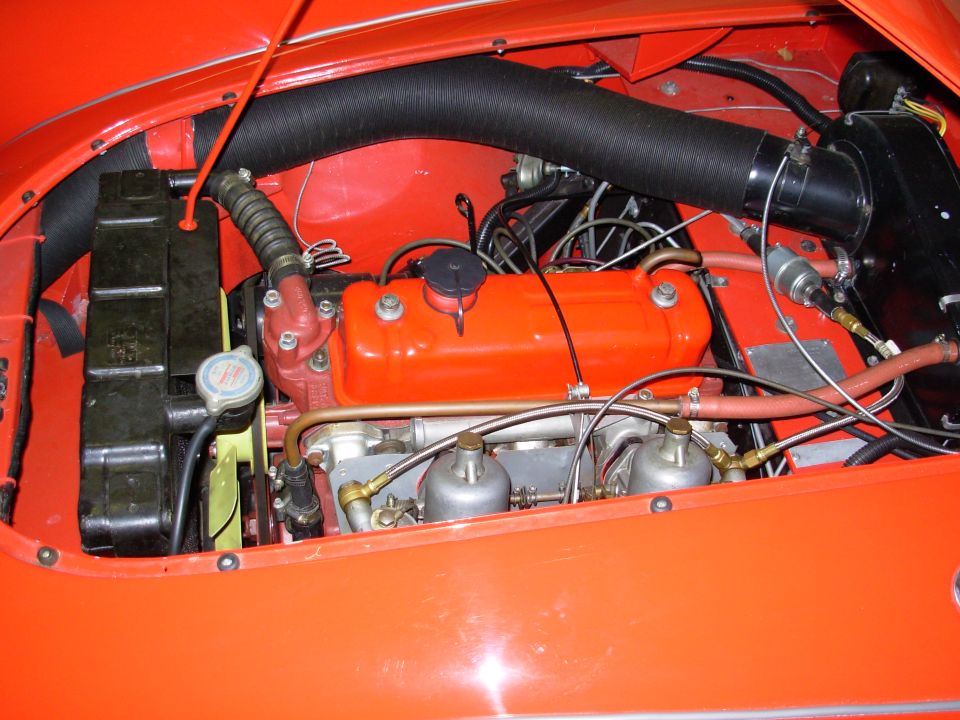 The flash is washing out some of the color. The car is actually very red.