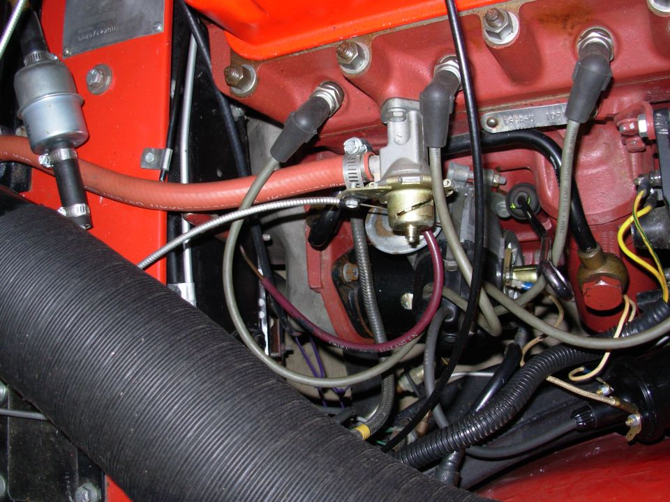 Engine bay detail with red block, fuel filter, and spark plug wires