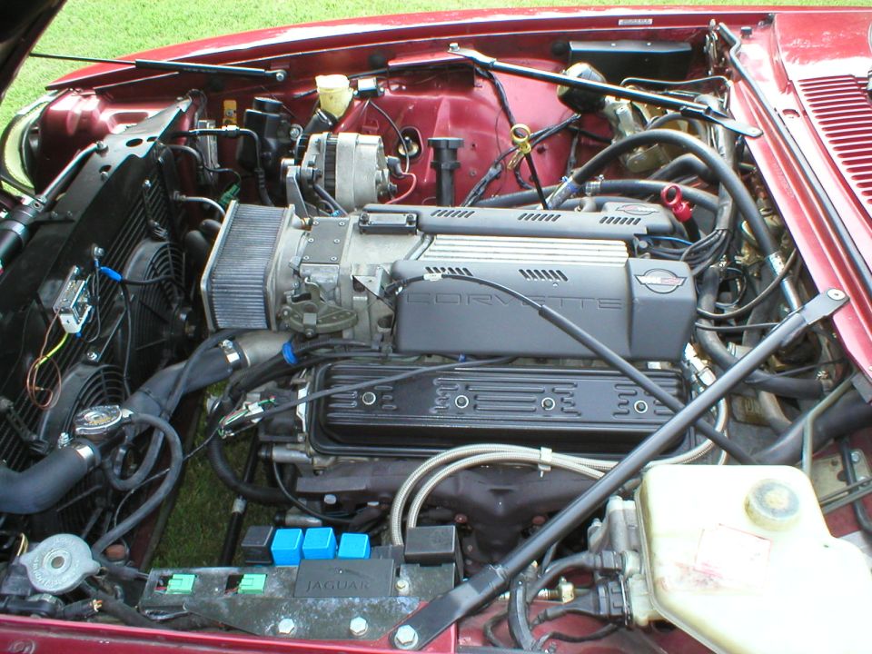Chevrolet Corvette V8 engine swapped into a maroon Jaguar engine bay