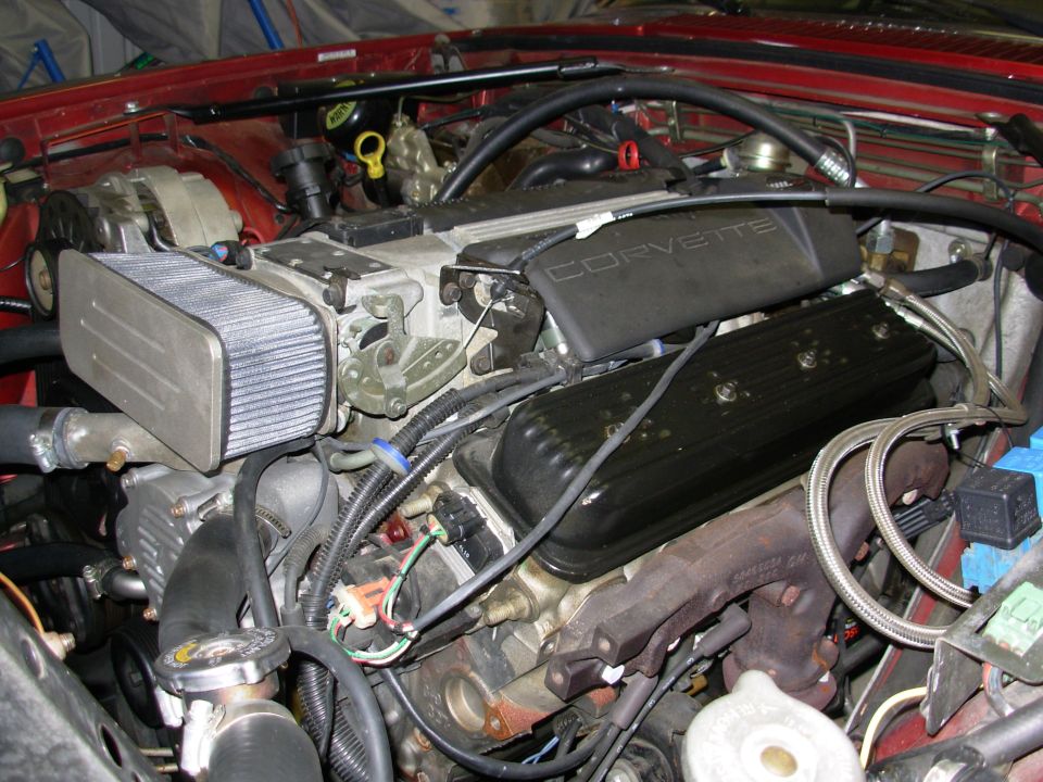 Engine bay with a large air filter and a black cover labeled CORVETTE