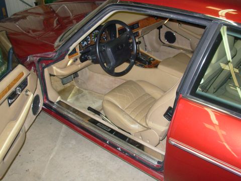 1992 Jaguar XJ-S - Interior view of a red Jaguar XJ-S, showing tan leather seats and dashboard details.