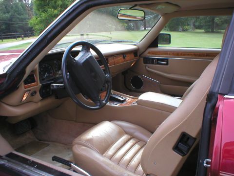 1992 Jaguar XJ-S - The interior of a 1992 Jaguar XJ-S features tan leather seats, wood trim, and a classic dashboard layout.
