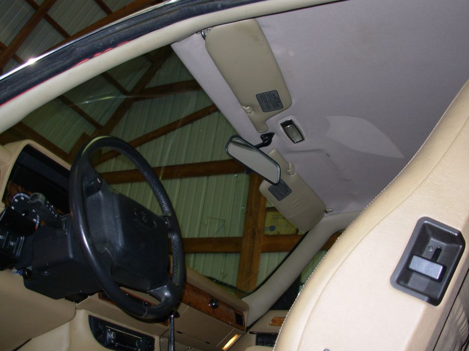 1992 Jaguar XJ-S interior showing dashboard, steering wheel, sun visors, and rearview mirror