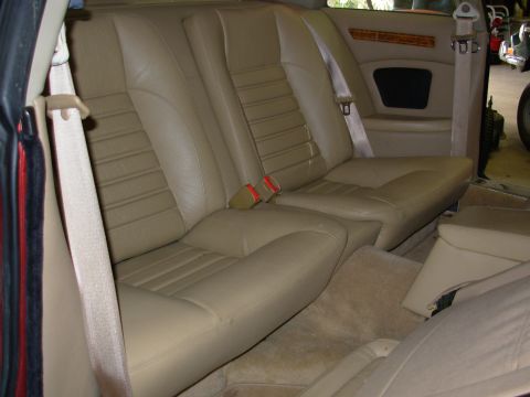 1992 Jaguar XJ-S - The interior of a 1992 Jaguar XJ-S shows tan leather rear seats and beige seatbelts.