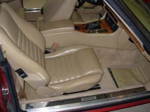 1992 Jaguar XJ-S - Interior view of a Jaguar, showing tan leather seats and wood trim on the center console.