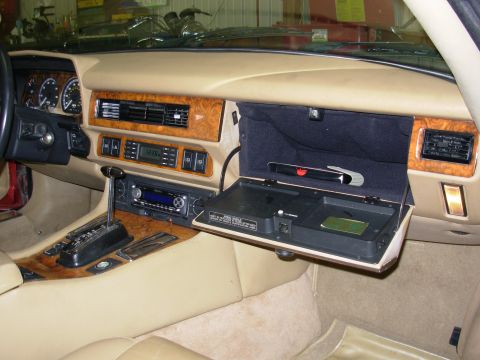 1992 Jaguar XJ-S - The interior of a 1992 Jaguar XJ-S features wood trim and an open glove box.