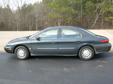 1999 Mercury Sable - Side profile of a 1999 Mercury Sable sedan parked outdoors on an asphalt surface.