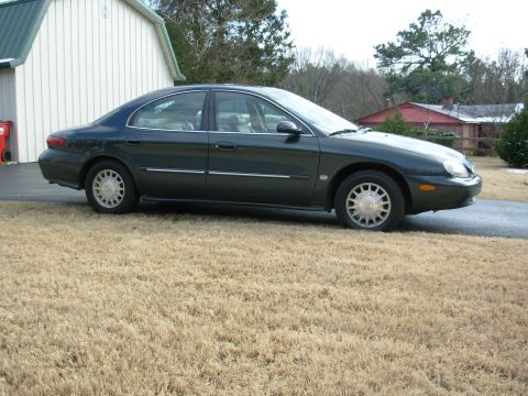1999 Mercury Sable - This 1999 Mercury Sable is shown from the side, parked on dry grass next to a building.