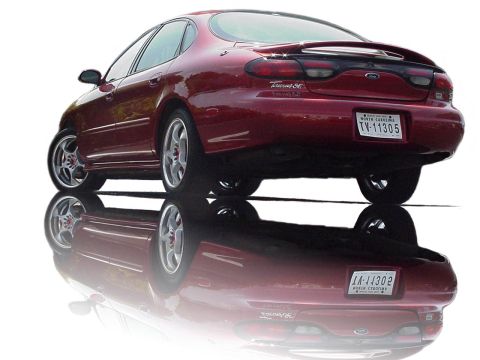 1998 Ford Taurus - Rear view of a red 1998 Ford Taurus SE sedan with custom wheels.