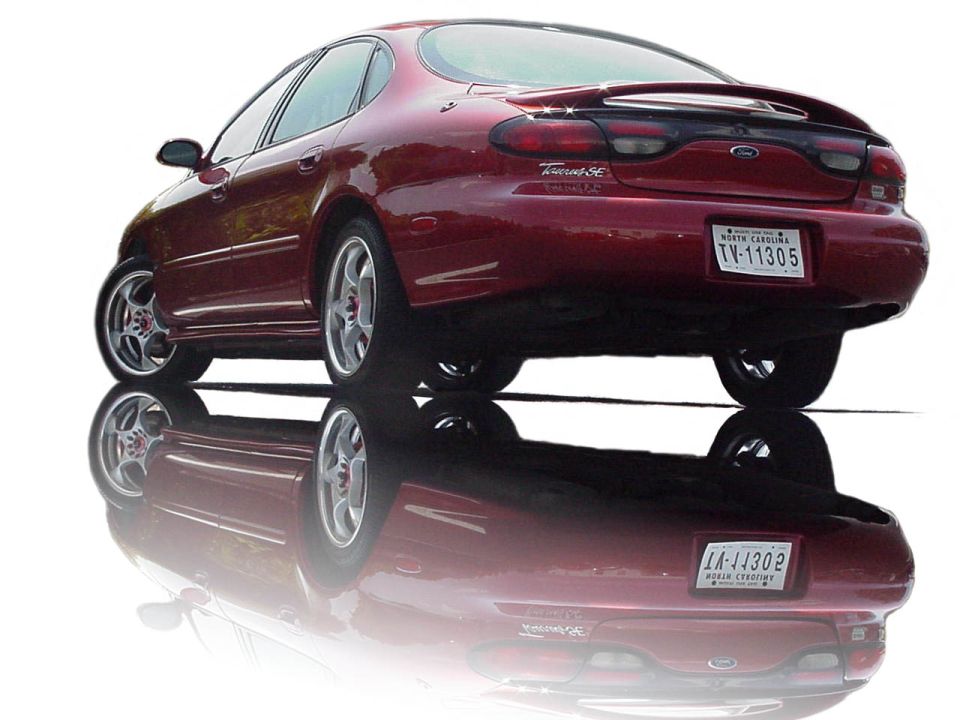 1998 Ford Taurus SE rear quarter view, red paint, custom wheels
