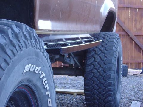 1986 Ford Bronco II - The vehicle has large Mud-Terrain tires and a metal step installed below the body.