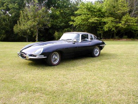 1967 Jaguar XKE - A classic Jaguar E-Type Series 1.5 Coupe sits on a grassy field, ready for a drive.