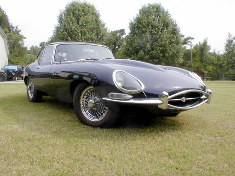 1967 Jaguar XKE - A classic 1967 Jaguar XKE coupe is shown from a three-quarter front view, its iconic design and wire wheels.