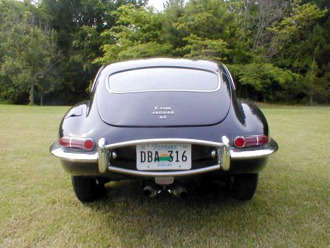 1967 Jaguar XKE - Rear view of a 1967 Jaguar XKE coupe, showing taillights and dual exhaust pipes.
