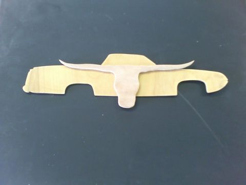 1979 Ford Ranchero - A wooden cutout depicts a pickup truck profile with a longhorn skull emblem.