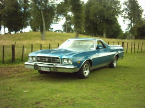 1973 Ford Ranchero - Blue 1973 Ford Ranchero pickup truck sits in a grassy field.
