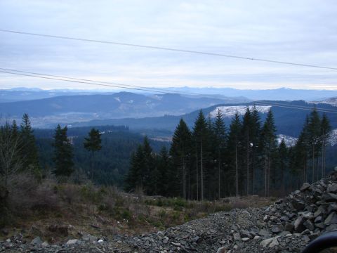1996 Ford Bronco - A wide shot of a mountainous landscape with evergreen trees and power lines stretching across the sky.