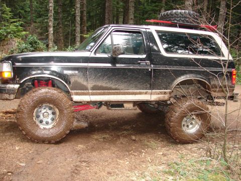 1996 Ford Bronco - This lifted 1996 Ford Bronco is covered in mud after navigating a forest trail.