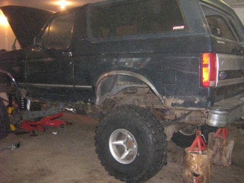 1995 Ford Bronco - This 1995 Ford Bronco is being worked on, with the hood open and the vehicle elevated.