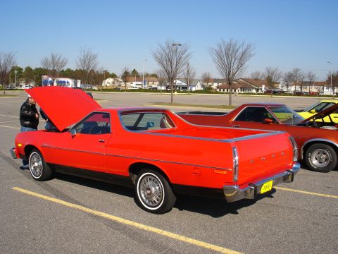 1979 Ford Ranchero - A bright red 1979 Ford Ranchero is displayed with its hood open, parked next to another similar vehicle.
