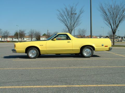 1979 Ford Ranchero - A yellow coupe utility is parked in a lot on a clear day.