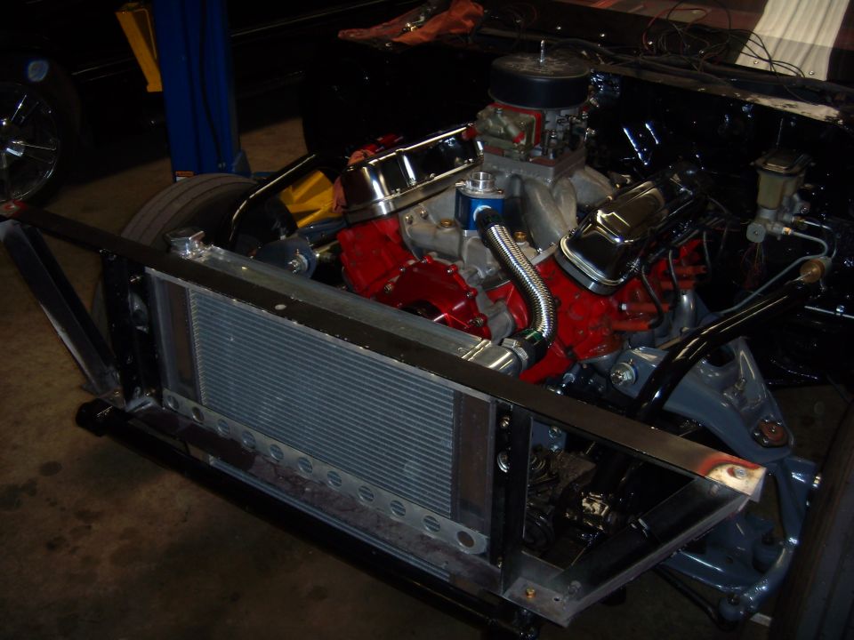 Engine and radiator assembly with red block and chrome valve covers