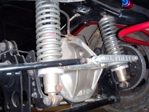 1984 Ford Bronco - Close-up view of a modified rear axle assembly with "AFW" and "ULTIMATE" markings on its components.