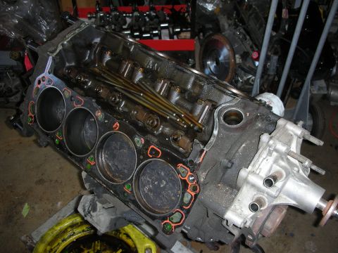 1990 Ford Mustang - Engine block with cylinders exposed, showing valve train components and gasket remnants.