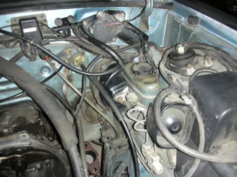1990 Ford Mustang - This image shows various engine bay components, including the brake master cylinder and associated plumbing and wiring.