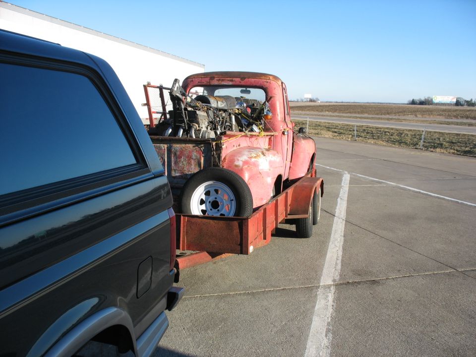1952 Ford Pickup being towed on a trailer, rear view