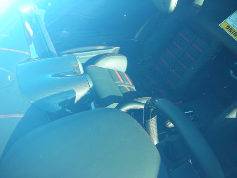 1998 Ford Crown Victoria - View through a tinted windshield into a black sports-car interior with red stitching, sport seats and steering wheel.