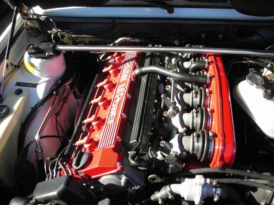 Red BMW M Power inline-six engine in detailed engine bay