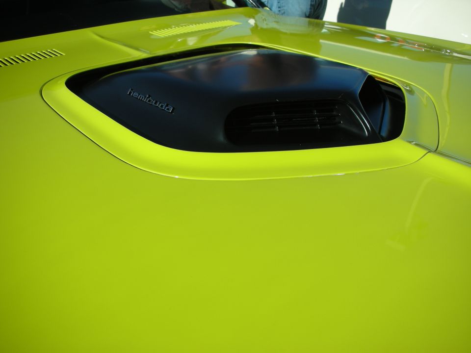 Close-up of green hood scoop with hemicuda lettering on a muscle car